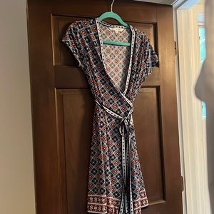 Patterned navy V neck wrap dress